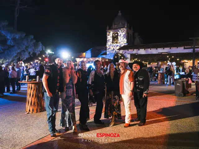 Guests posing for a portrait in the Carmel Mission courtyard at night at Taste of Carmel 2026