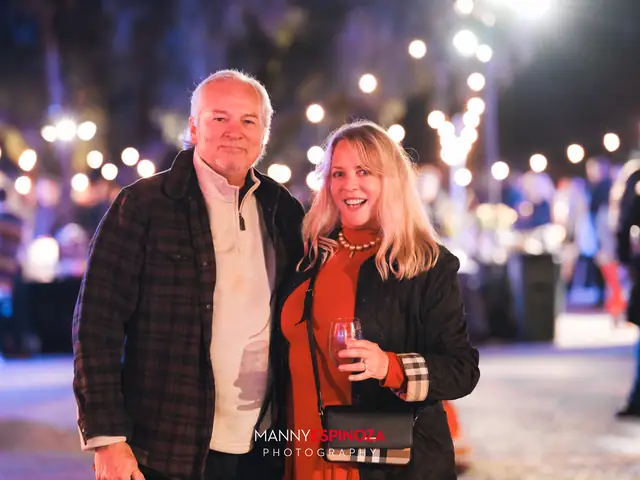 Guests posing for a portrait in the Carmel Mission courtyard at night at Taste of Carmel 2026