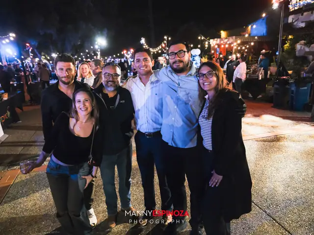 Guests posing for a portrait in the Carmel Mission courtyard at night at Taste of Carmel 2026
