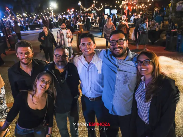 Guests posing for a portrait in the Carmel Mission courtyard at night at Taste of Carmel 2026