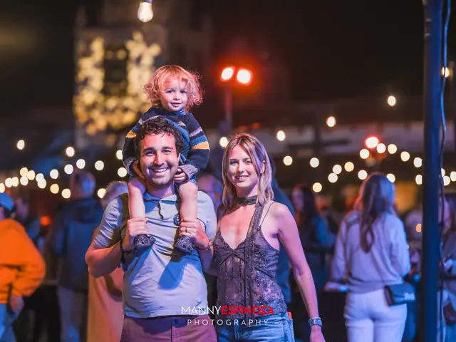 A child on his father's shoulders with his mother beside them under string lights at Taste of Carmel 2026