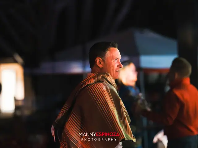 A guest in a striped serape at night at Taste of Carmel 2026