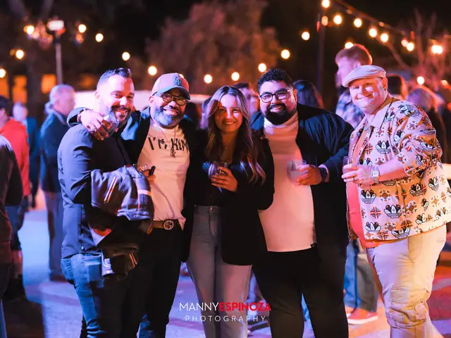 Group of friends posing together at night at Taste of Carmel 2026