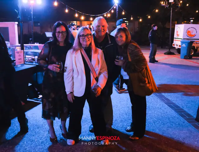 Guests posing for a portrait in the Carmel Mission courtyard at night at Taste of Carmel 2026