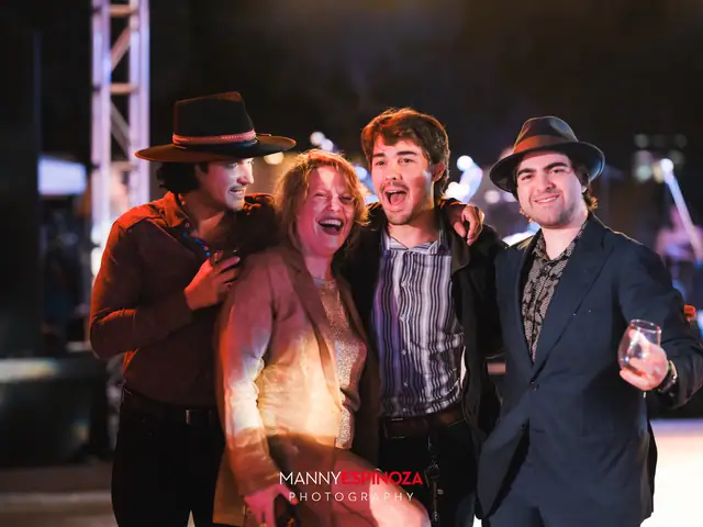Group of four guests posing under the stage truss at Taste of Carmel 2026