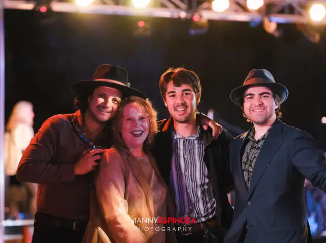 Group of four guests posing under the stage truss at Taste of Carmel 2026