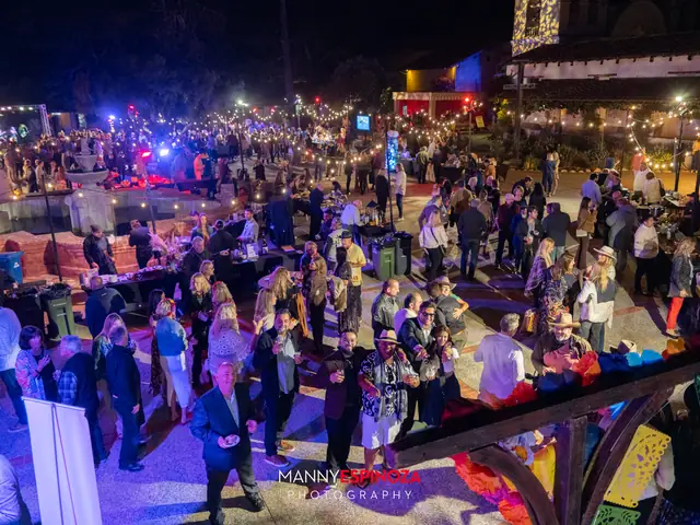 Elevated view of the crowd, vendor booths and string lights in the Carmel Mission courtyard at Taste of Carmel 2026