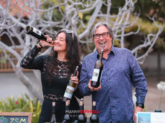 Guests laughing and pouring wine straight from the bottle at Taste of Carmel 2026