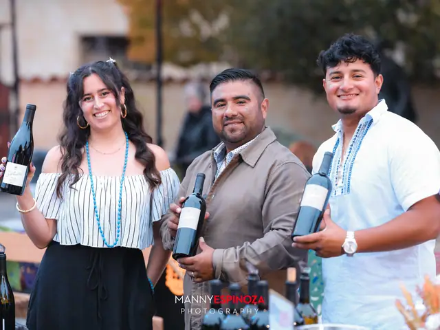 Three people from a winery pouring and holding bottles at Taste of Carmel 2026