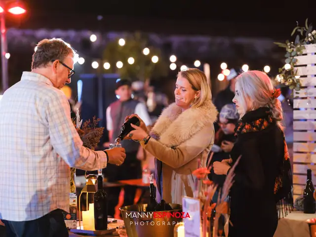 Guests sampling wine at a tasting table at night at Taste of Carmel 2026