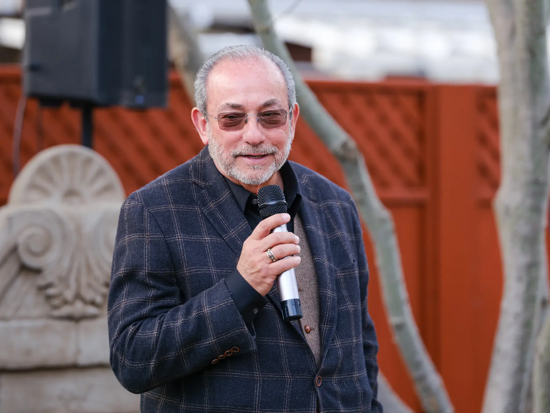 Charles Gruwell speaking into a microphone at the grand opening ribbon-cutting for The Charles Napa Valley