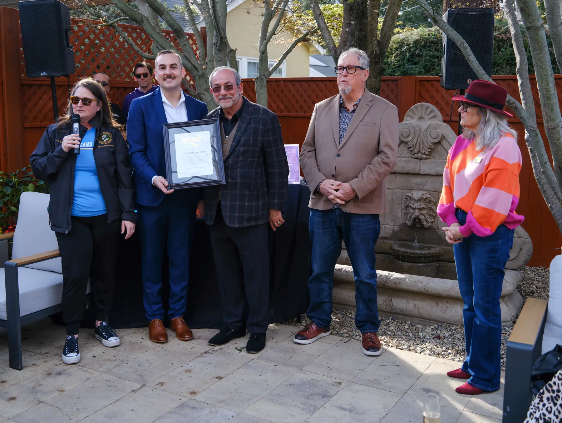 Charles Gruwell and community leaders holding a framed California State Senate Certificate of Recognition for The Charles Napa Valley at the February 21, 2026 grand opening