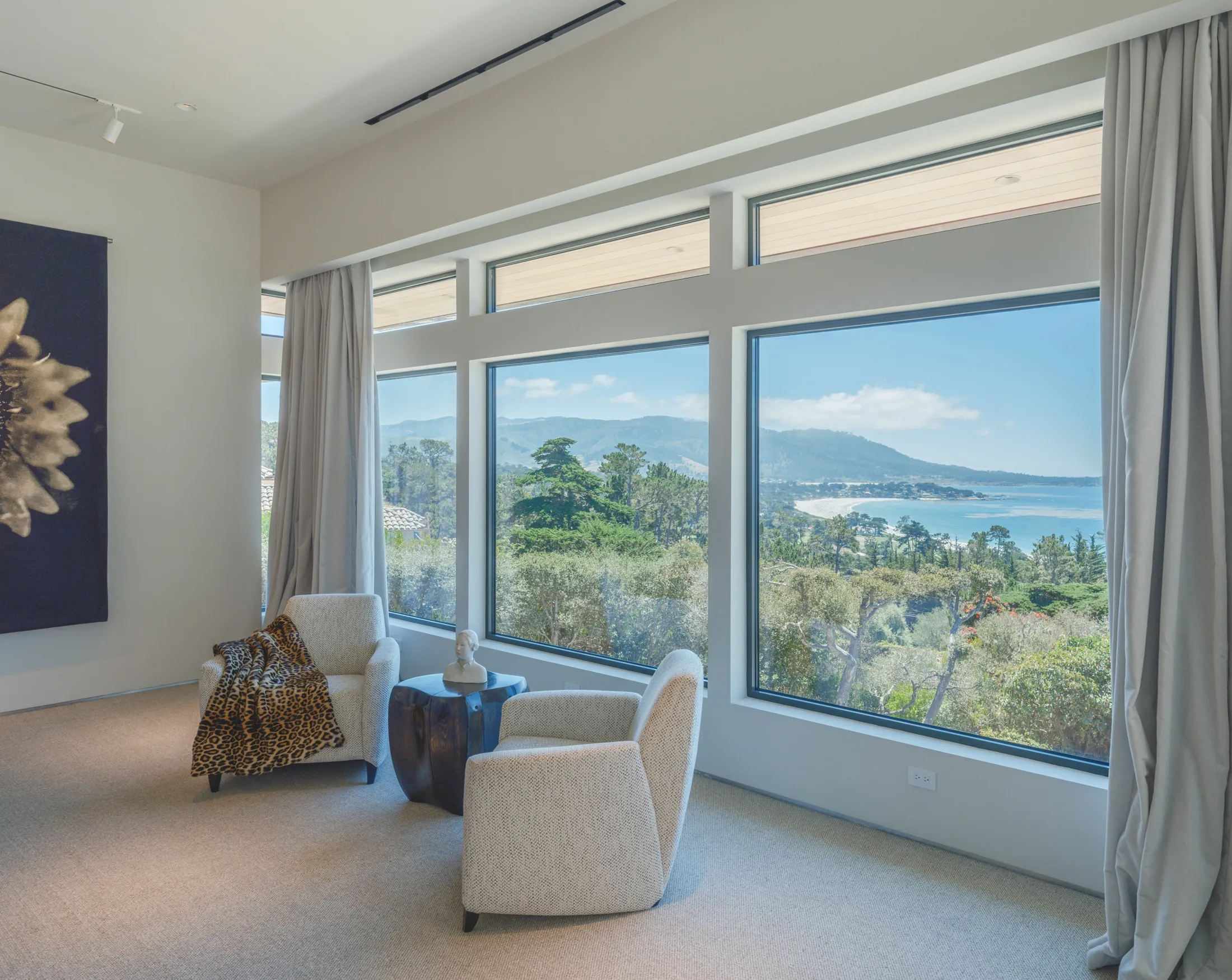 Interior of The Edge with floor-to-ceiling windows framing Carmel Bay, single exposure by Manny Espinoza