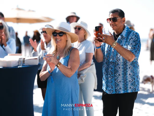 Guests applauding and raising glasses during the program at Walk for Freedom 2026 on Carmel Beach