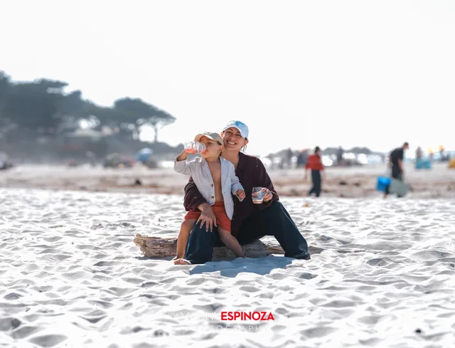 A couple sitting on a driftwood log near the water at Walk for Freedom 2026 on Carmel Beach