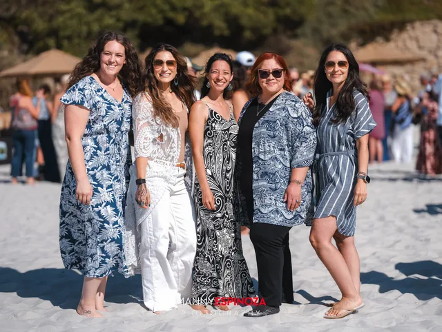 Five women in blue and white prints standing in a row at Walk for Freedom 2026 on Carmel Beach