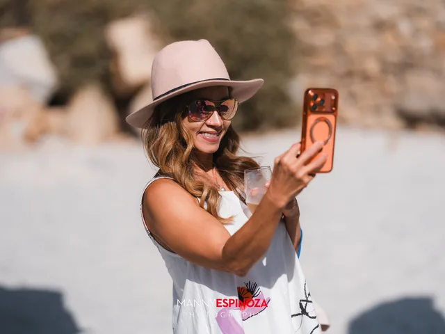 A guest in a felt hat taking a selfie at Walk for Freedom 2026 on Carmel Beach