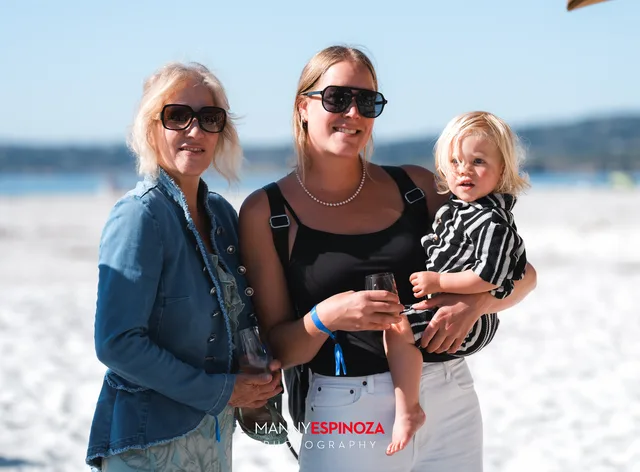 Two women with a toddler in a striped shirt at Walk for Freedom 2026 on Carmel Beach