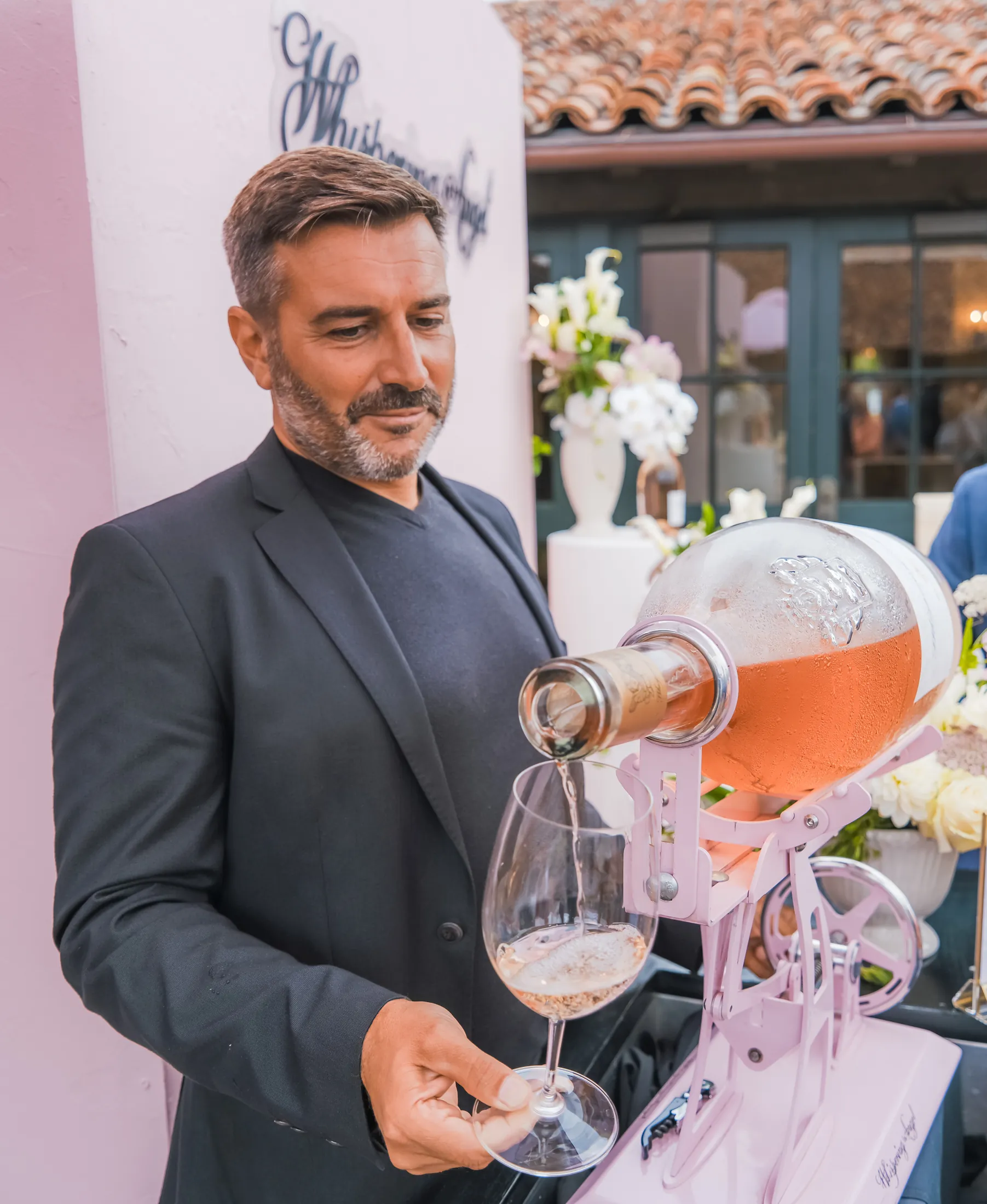 Whispering Angel rosé poured from a large format bottle on a cradle at the Monterey Peninsula Country Club during Car Week